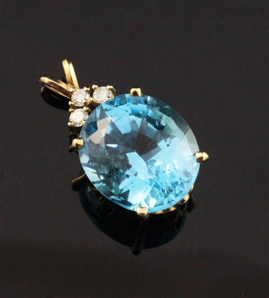 A gold, blue topaz and diamond pendant, approx. 1in.